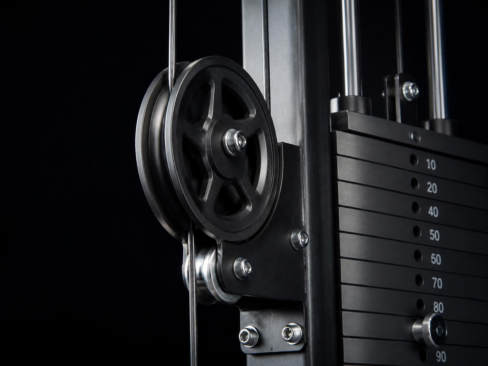 Close-up of a commercial resistance machine pulley and weight stack